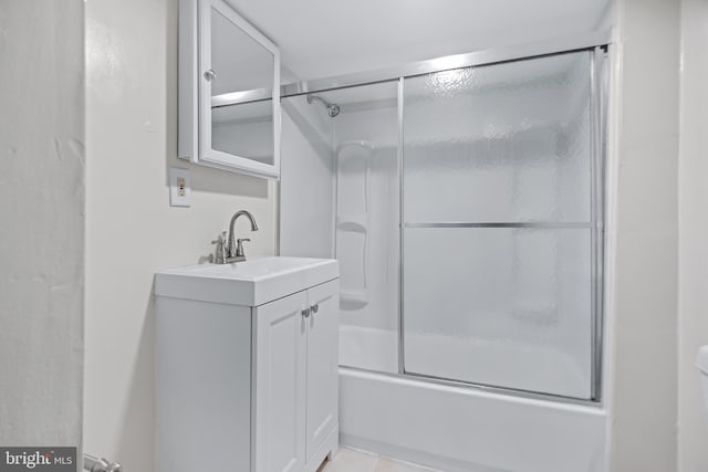 bathroom featuring vanity and enclosed tub / shower combo