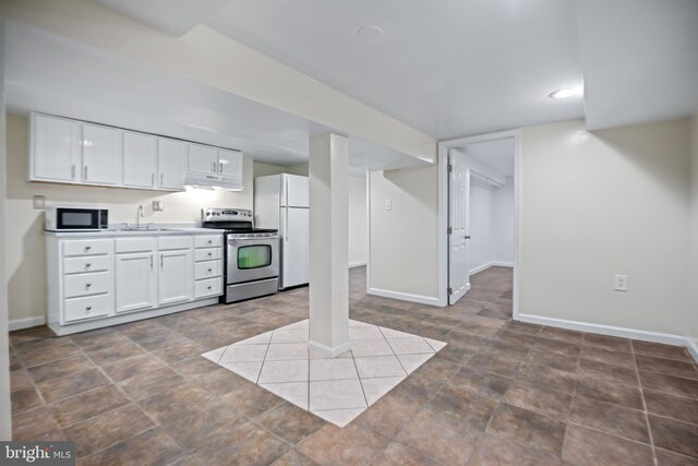 kitchen with stainless steel electric range oven, sink, light tile patterned floors, white cabinets, and white fridge