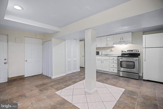 kitchen with sink, white fridge, white cabinets, and stainless steel electric range oven