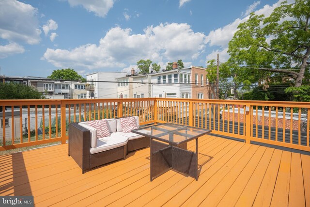 wooden terrace with an outdoor hangout area