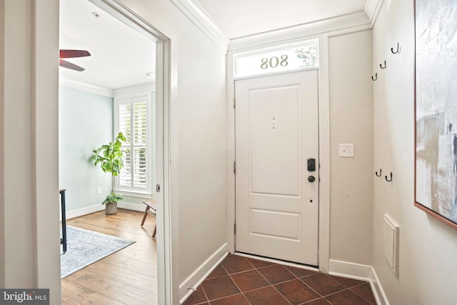 entrance foyer with ceiling fan, wood-type flooring, and ornamental molding