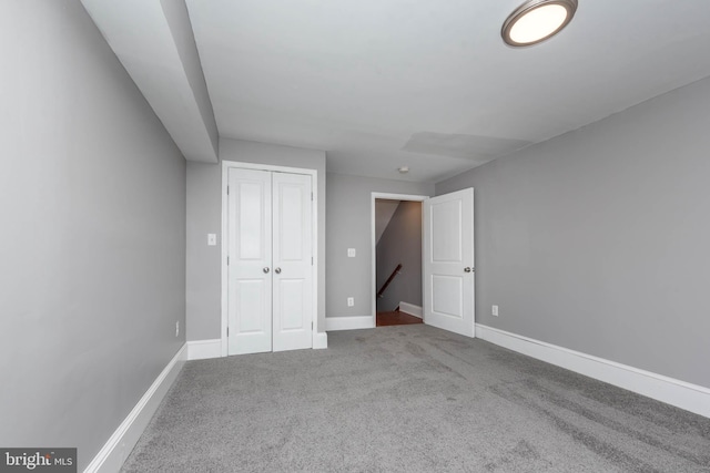 unfurnished bedroom featuring carpet floors and a closet