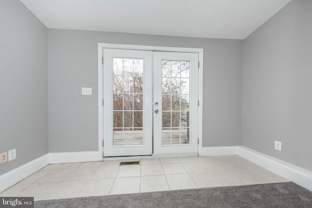 doorway with light tile patterned flooring and french doors