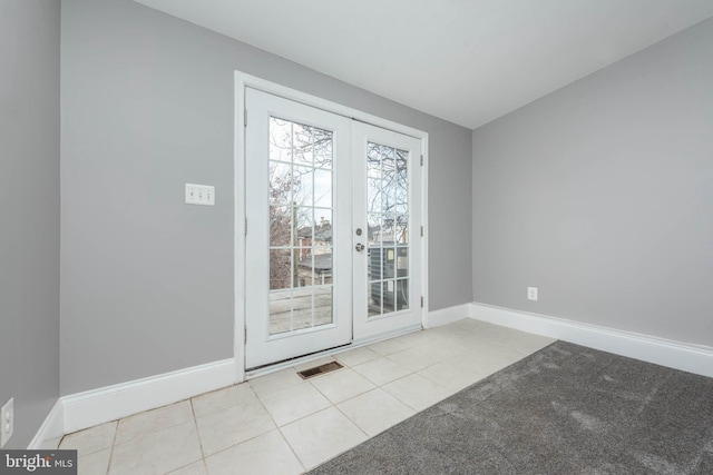 doorway featuring light tile patterned floors and french doors