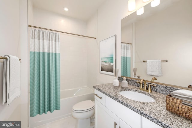 full bathroom with vanity, shower / tub combo, and toilet