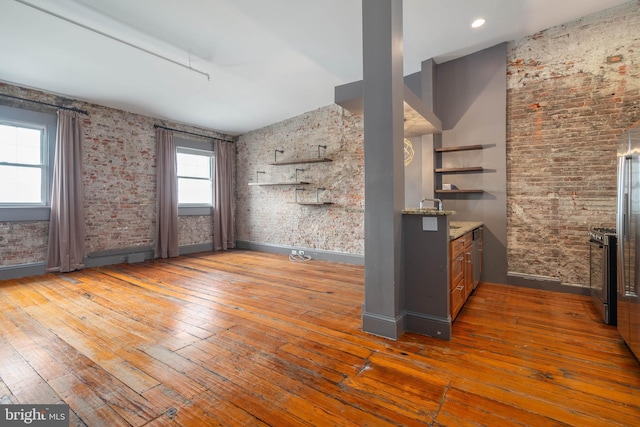 interior space with stainless steel range with gas cooktop and hardwood / wood-style flooring