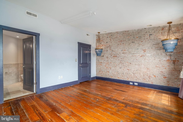 unfurnished room with hardwood / wood-style floors