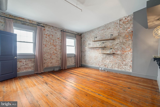 unfurnished room with hardwood / wood-style floors and a wealth of natural light