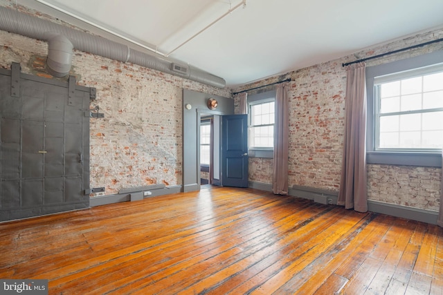 spare room featuring light wood-type flooring and lofted ceiling