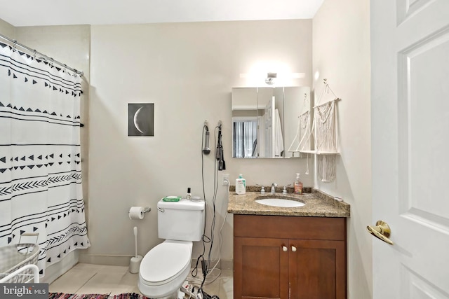 bathroom featuring tile patterned flooring, toilet, and vanity