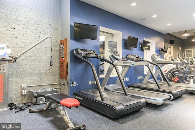 gym featuring brick wall