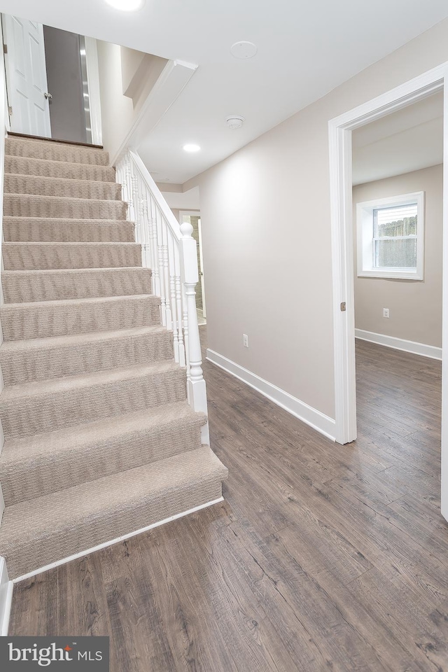 stairs featuring hardwood / wood-style flooring