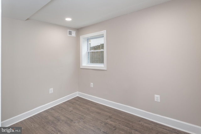 spare room featuring dark hardwood / wood-style flooring