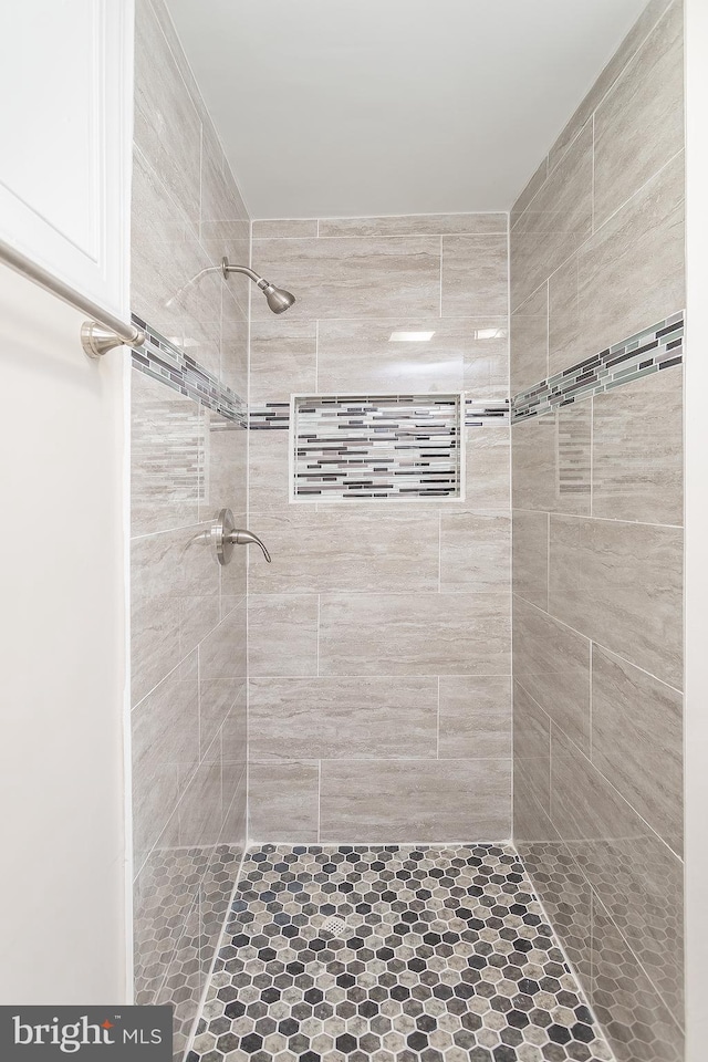 bathroom with a tile shower