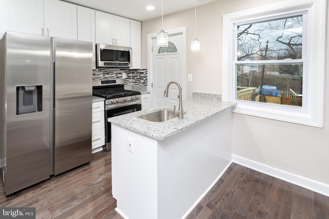 kitchen featuring white cabinetry, sink, hanging light fixtures, kitchen peninsula, and stainless steel appliances