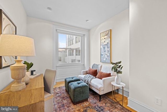 living area with hardwood / wood-style flooring