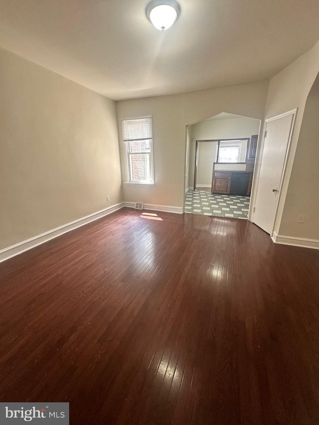 unfurnished living room featuring dark hardwood / wood-style floors