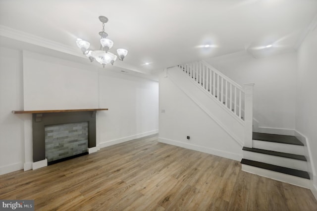 unfurnished living room with hardwood / wood-style flooring and a chandelier