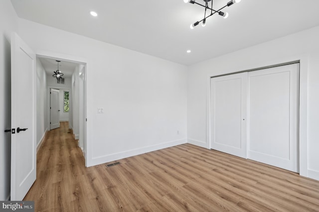 unfurnished bedroom featuring light hardwood / wood-style floors and a closet