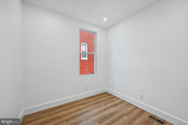 spare room with hardwood / wood-style floors