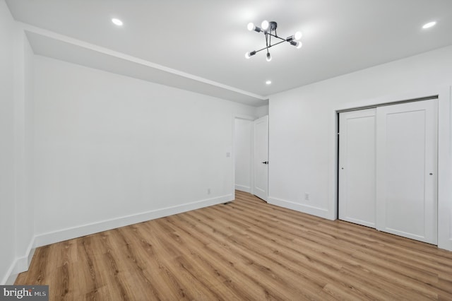 unfurnished bedroom featuring a closet and light wood-type flooring