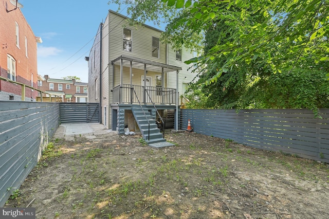 back of house featuring a porch