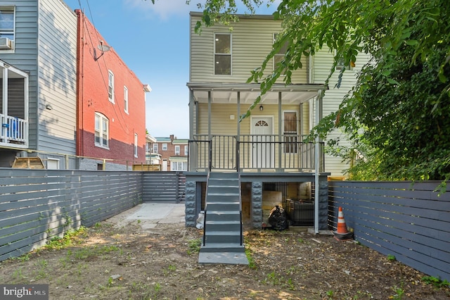 back of property with covered porch