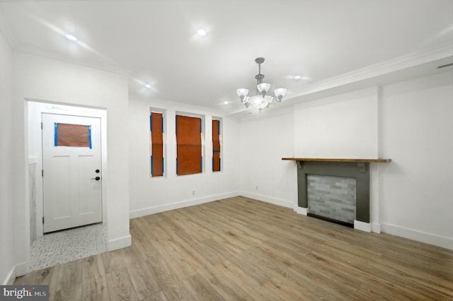 unfurnished living room featuring hardwood / wood-style flooring and an inviting chandelier