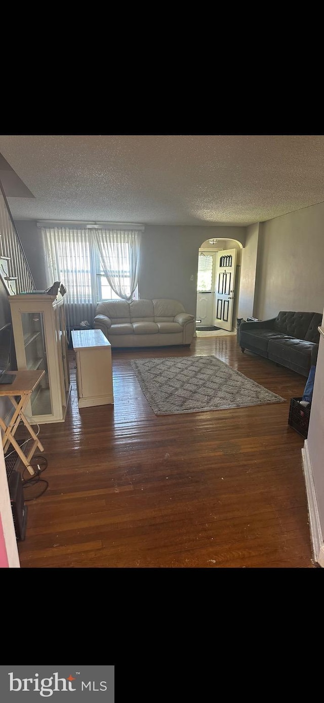 interior space with hardwood / wood-style floors and a textured ceiling