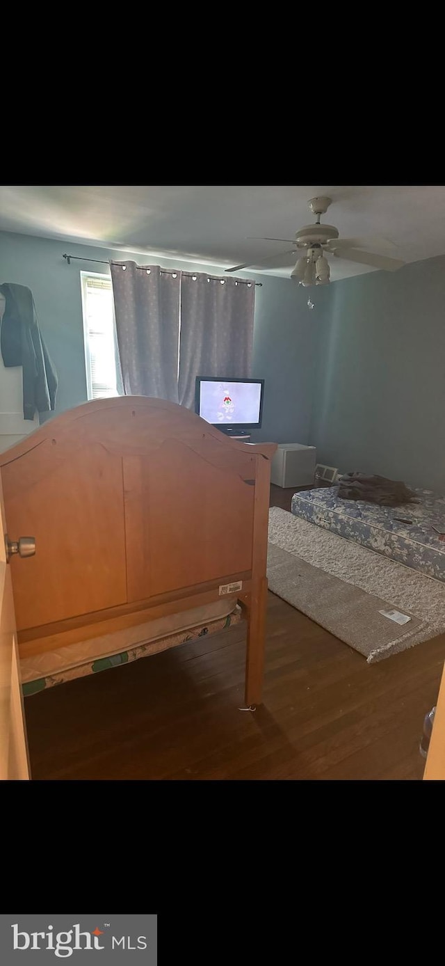 bedroom featuring hardwood / wood-style floors and ceiling fan