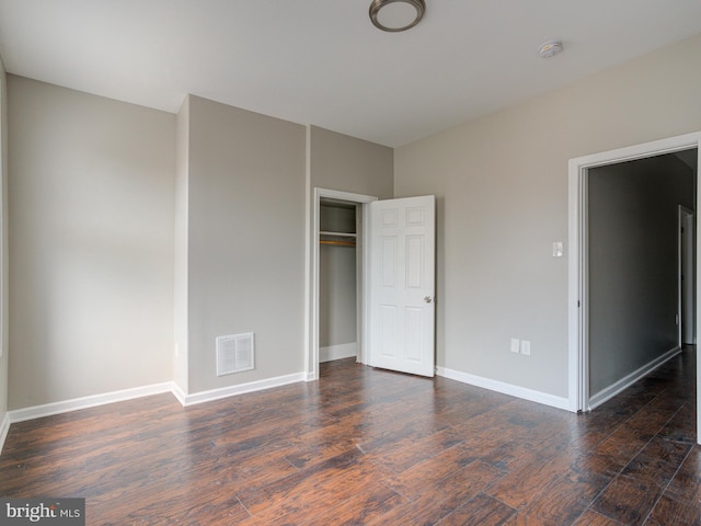 unfurnished bedroom featuring a closet and wood-type flooring