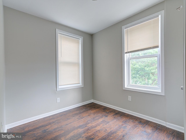 unfurnished room featuring dark hardwood / wood-style flooring