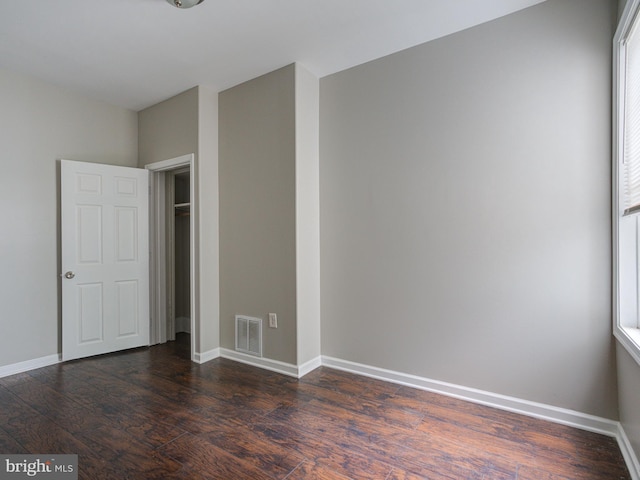 unfurnished bedroom featuring dark hardwood / wood-style floors