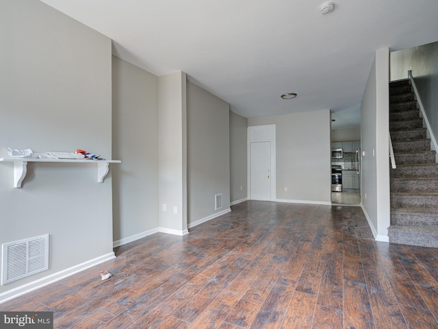 unfurnished living room featuring hardwood / wood-style flooring