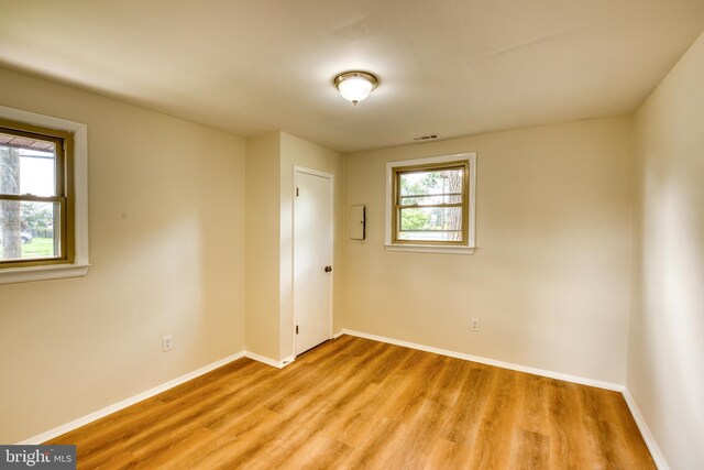 spare room with light hardwood / wood-style floors