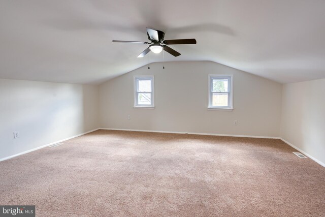 bonus room featuring vaulted ceiling, light colored carpet, and ceiling fan