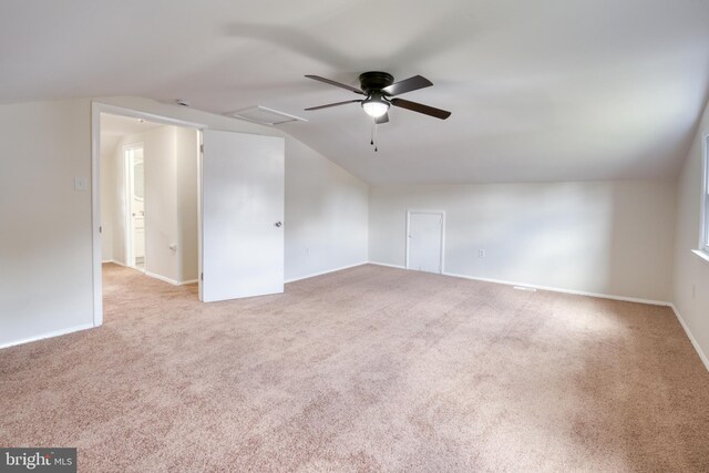 bonus room with vaulted ceiling, light colored carpet, and ceiling fan