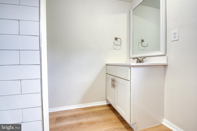 bathroom with vanity and wood-type flooring