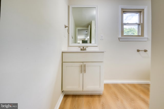 bathroom featuring hardwood / wood-style flooring and vanity