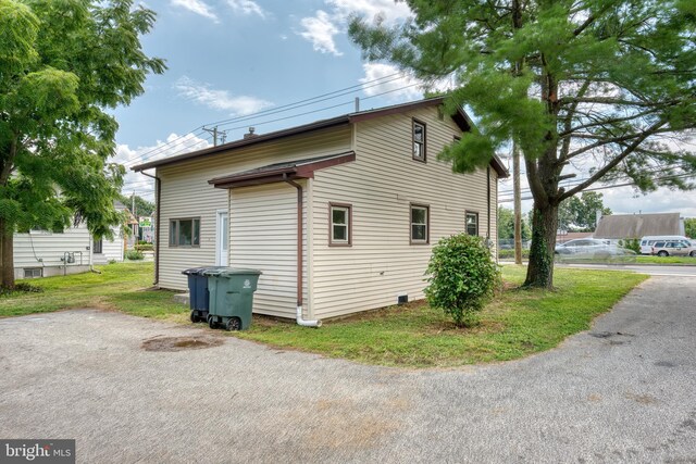 view of side of home featuring a yard