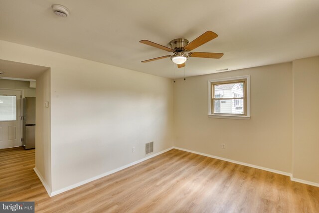 unfurnished room with ceiling fan and light wood-type flooring