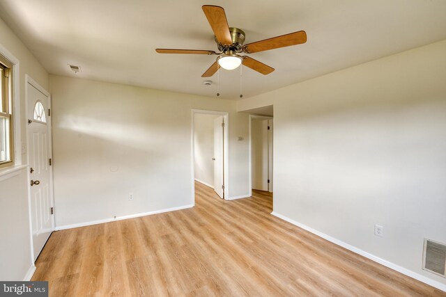 spare room with ceiling fan and light wood-type flooring