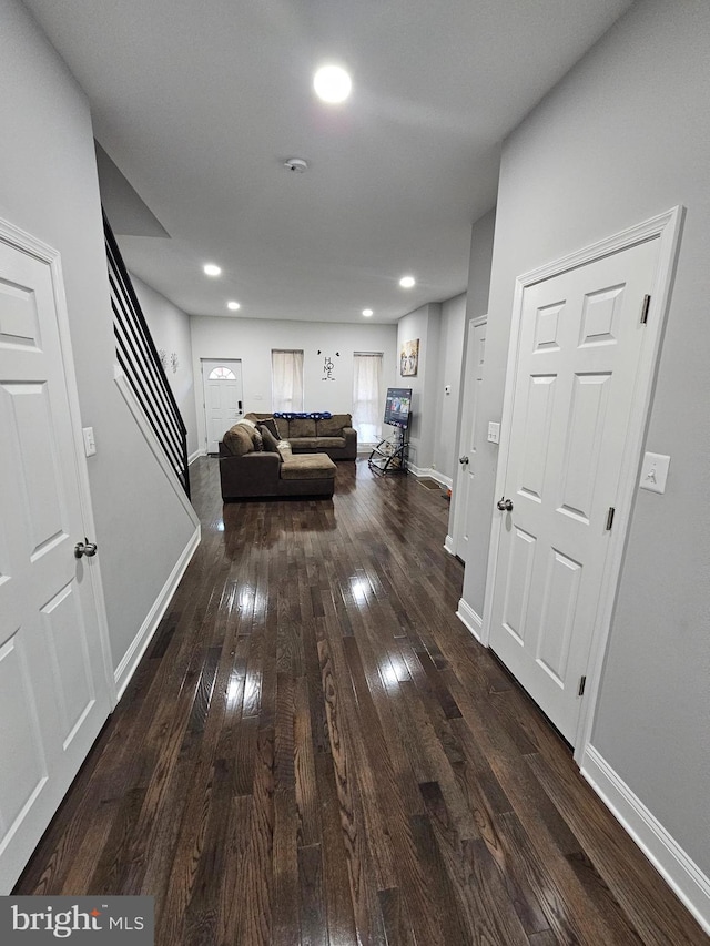 corridor featuring dark hardwood / wood-style floors