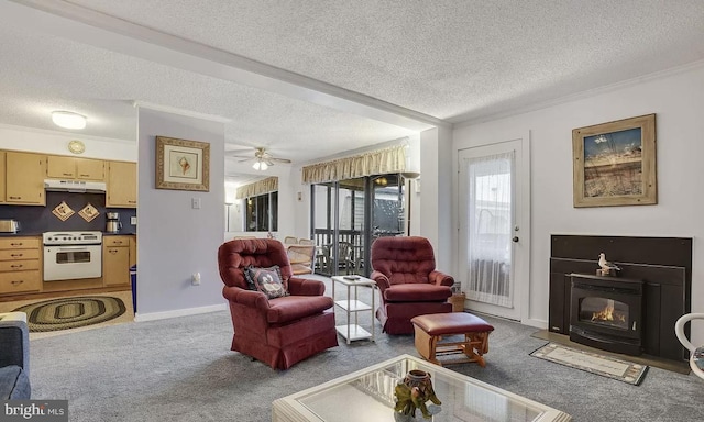 carpeted living room featuring ceiling fan, a wood stove, ornamental molding, and a textured ceiling