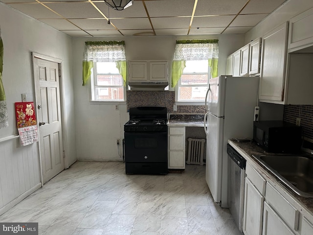 kitchen featuring white cabinetry, light tile patterned floors, black appliances, a paneled ceiling, and sink