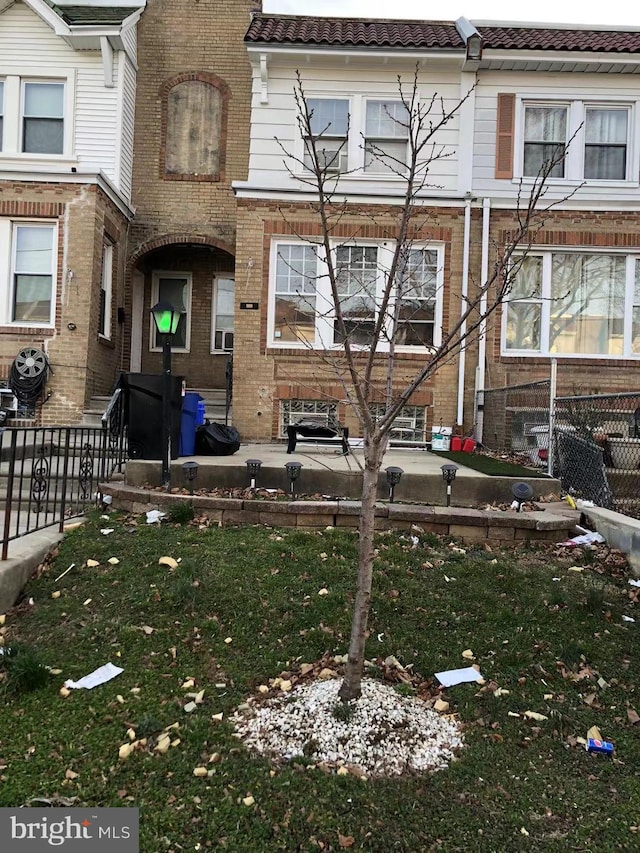 view of property featuring a front lawn