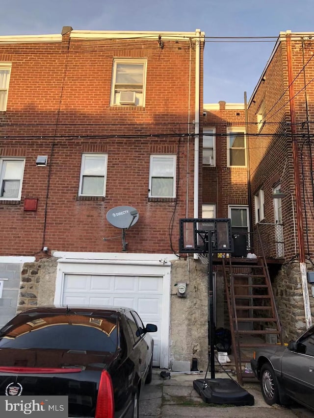 view of front of property with cooling unit and a garage