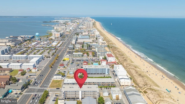 drone / aerial view featuring a view of the beach and a water view