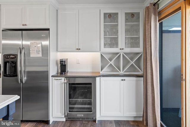 bar featuring white cabinets, stainless steel refrigerator with ice dispenser, beverage cooler, and dark hardwood / wood-style flooring