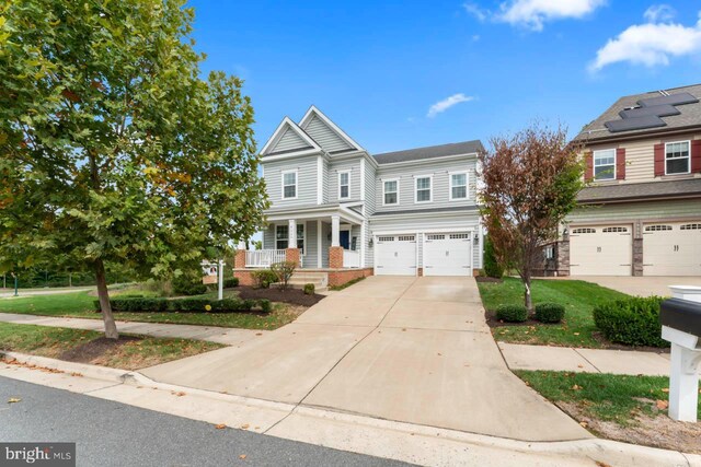 view of front of home with covered porch and a garage